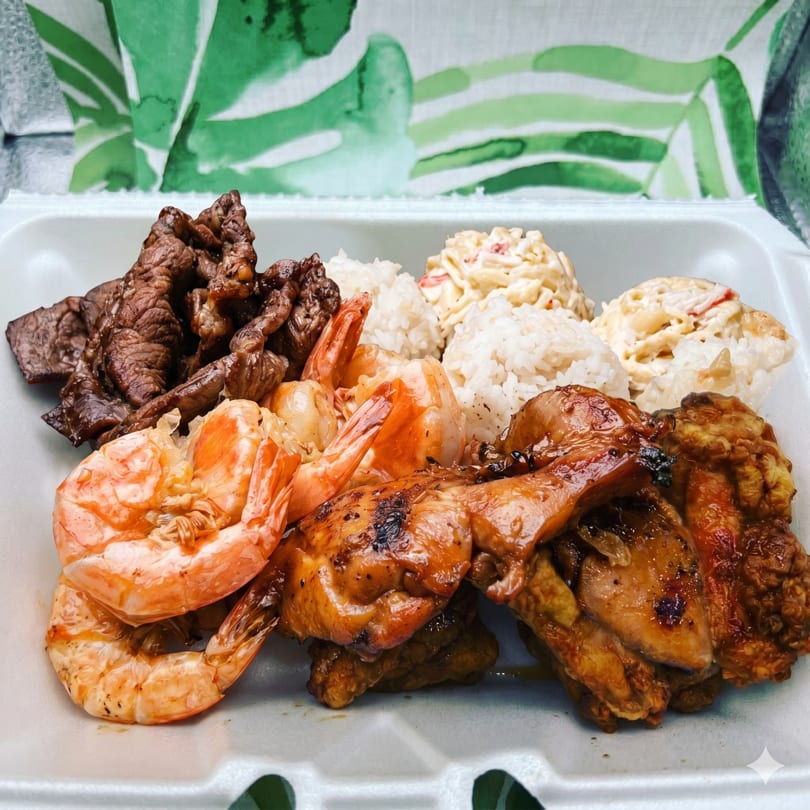 A takeout container filled with grilled shrimp, chicken, beef, white rice, and macaroni salad.